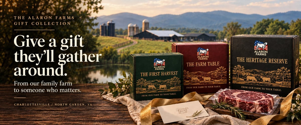 Alaron Farms green, burgundy, and black beef gift boxes styled on a wooden table with a farm landscape behind them